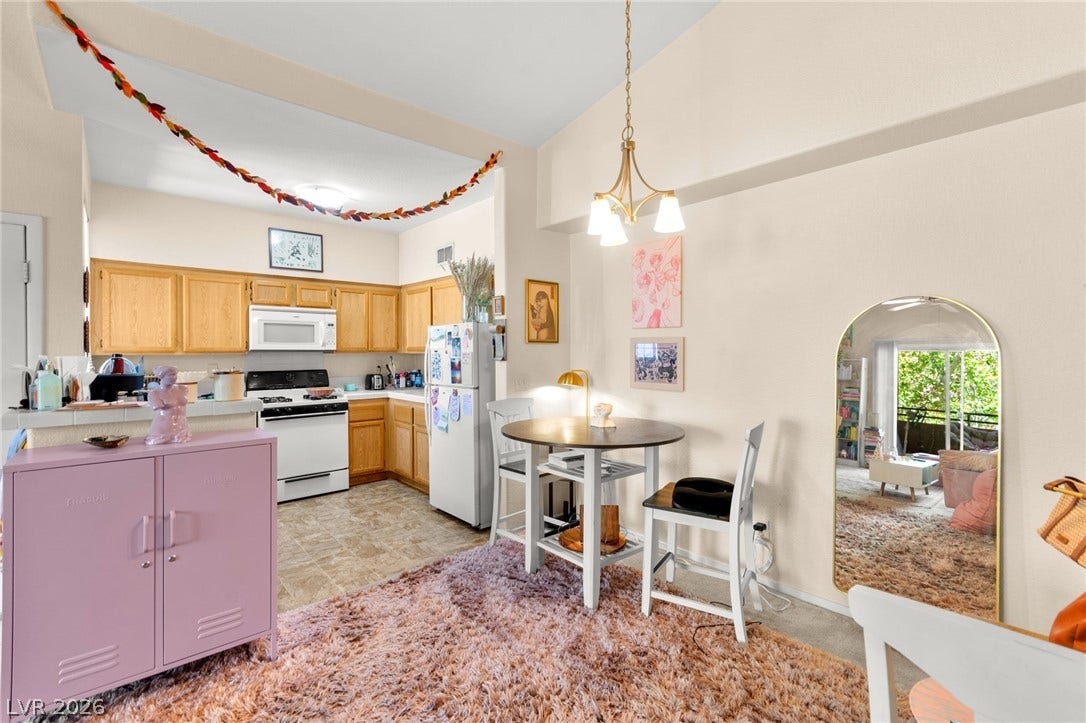 7628 Pacific Hills Avenue, #204, Las Vegas, NV 89128 An open dining area flows seamlessly into the kitchen under high ceilings.