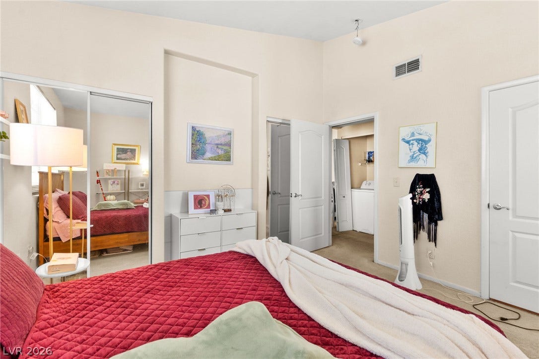 7628 Pacific Hills Avenue, #204, Las Vegas, NV 89128 High ceilings and neutral walls frame this comfortable bedroom with sliding mirrored closet doors.