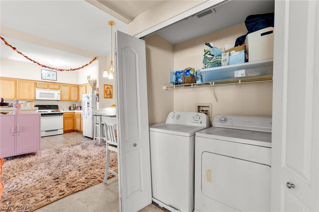 7628 Pacific Hills Avenue, #204, Las Vegas, NV 89128 A dedicated laundry closet sits adjacent to the open kitchen area.