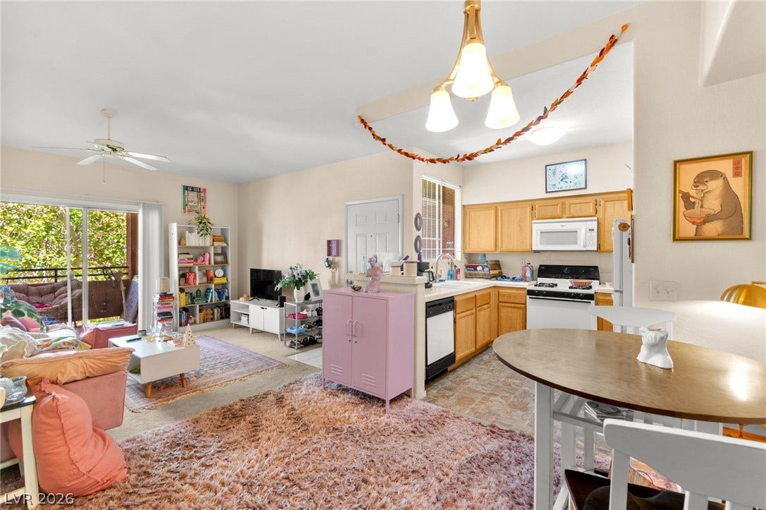 7628 Pacific Hills Avenue, #204, Las Vegas, NV 89128 An open floorplan seamlessly connects the comfortable living area with the functional kitchen space.