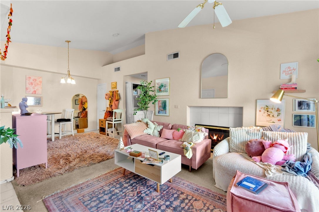 7628 Pacific Hills Avenue, #204, Las Vegas, NV 89128 An inviting fireplace serves as the focal point in this open living space.