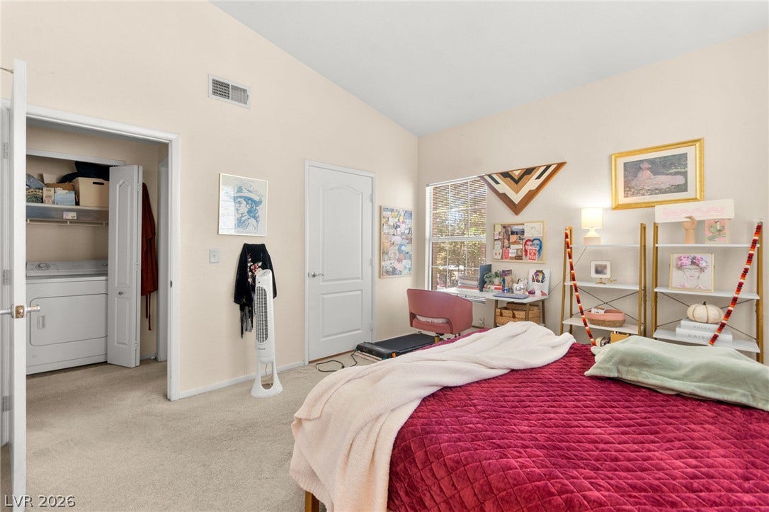 7628 Pacific Hills Avenue, #204, Las Vegas, NV 89128 High vaulted ceilings and soft carpeting define this comfortable bedroom space with an attached laundry closet.