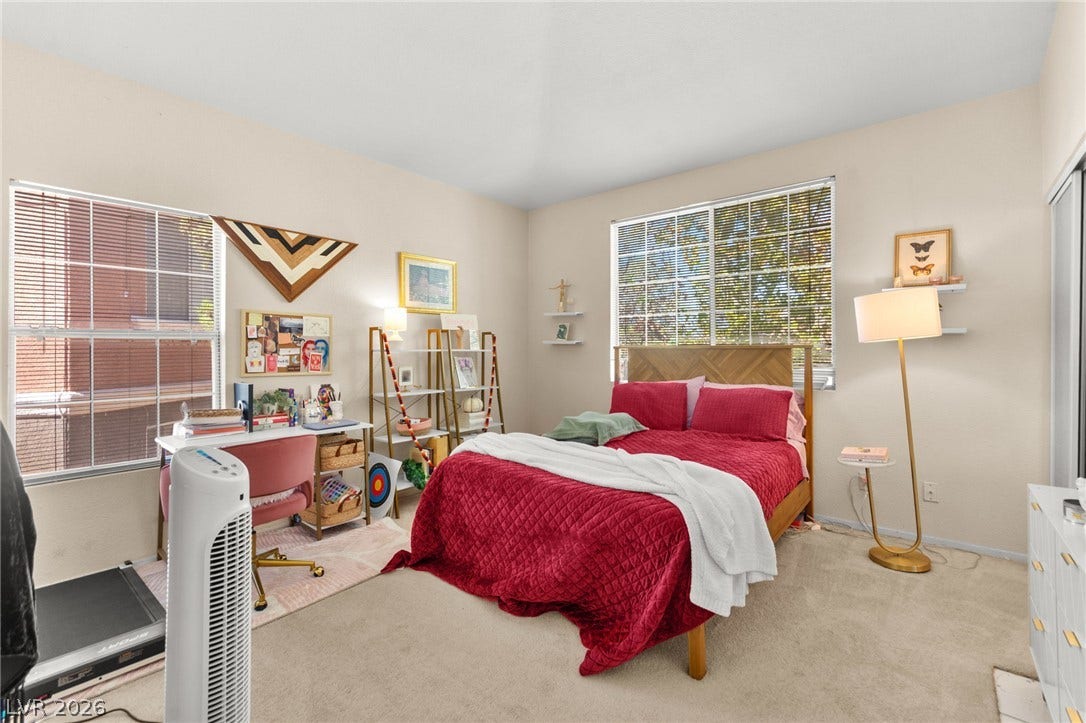 7628 Pacific Hills Avenue, #204, Las Vegas, NV 89128 Natural light pours through dual windows in this bedroom featuring neutral walls and carpeting.