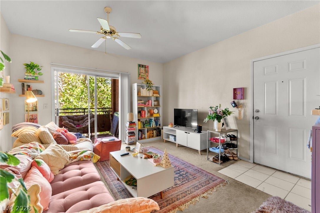 7628 Pacific Hills Avenue, #204, Las Vegas, NV 89128 Sliding glass doors open to a private balcony, filling the living area with natural light.