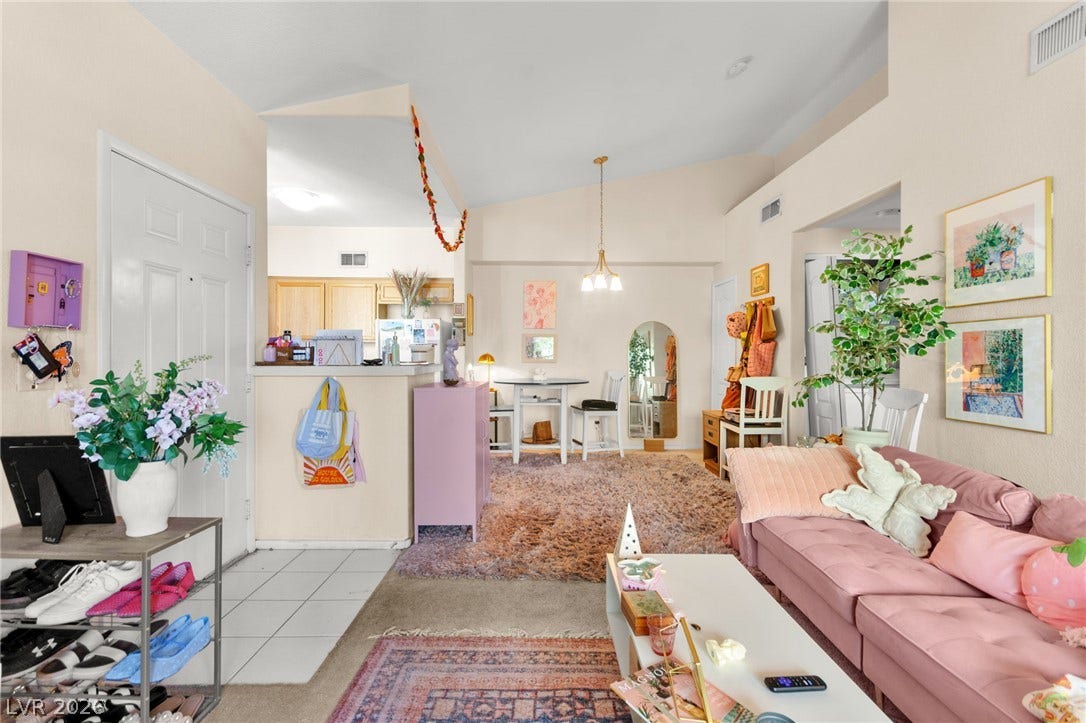 7628 Pacific Hills Avenue, #204, Las Vegas, NV 89128 Vaulted ceilings soar over the versatile open living area finished with plush carpet and tile.