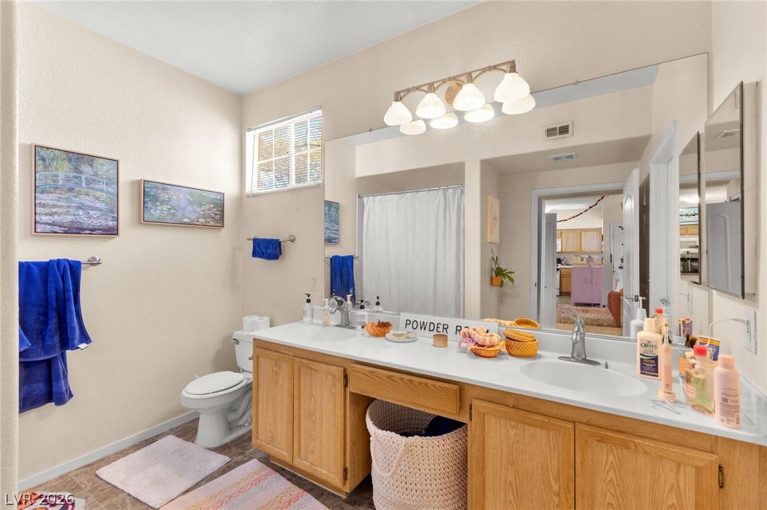7628 Pacific Hills Avenue, #204, Las Vegas, NV 89128 An expansive double vanity under a wide mirror defines this bright bathroom space.