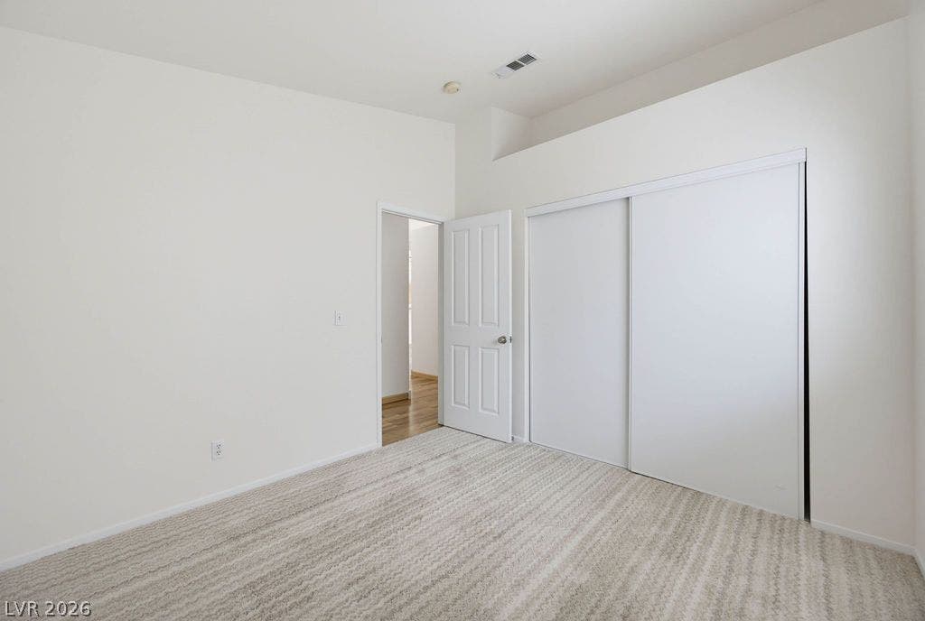 409 Groft Way, Henderson, NV 89015 Bedroo #2: High ceilings and neutral textured carpeting define this quiet secondary bedroom.