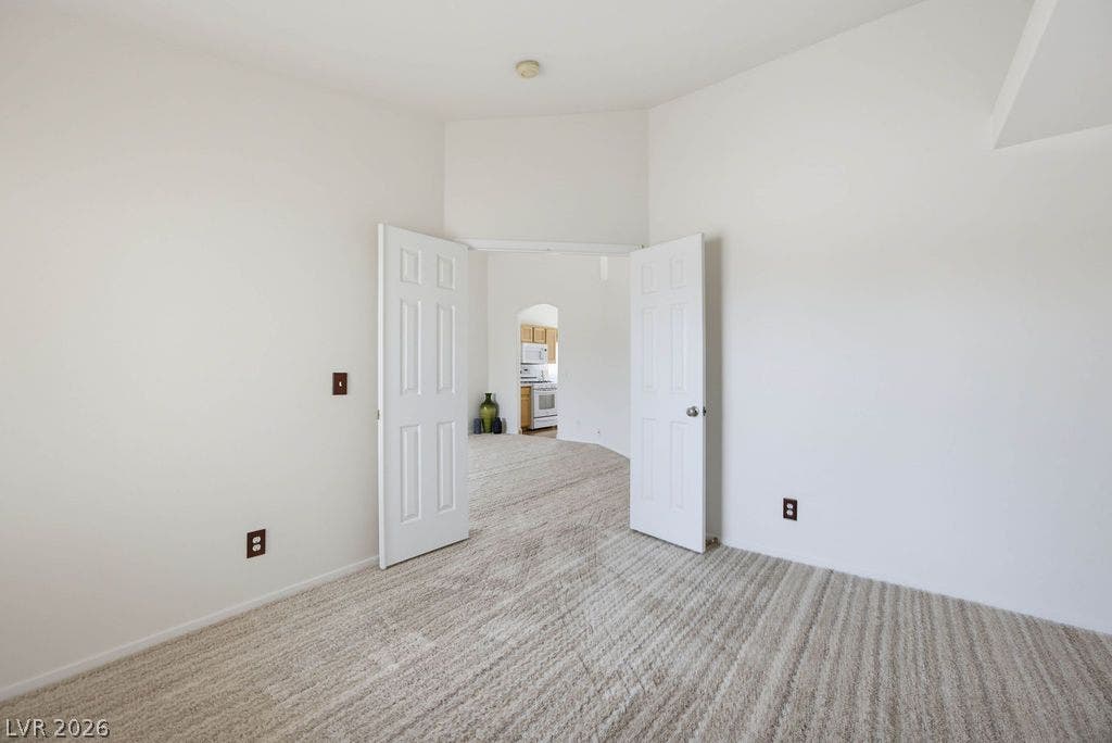 409 Groft Way, Henderson, NV 89015 Bedroom #3: French door entry from the front living room to reveal structured transitions and brand new carpeted floors throughout.