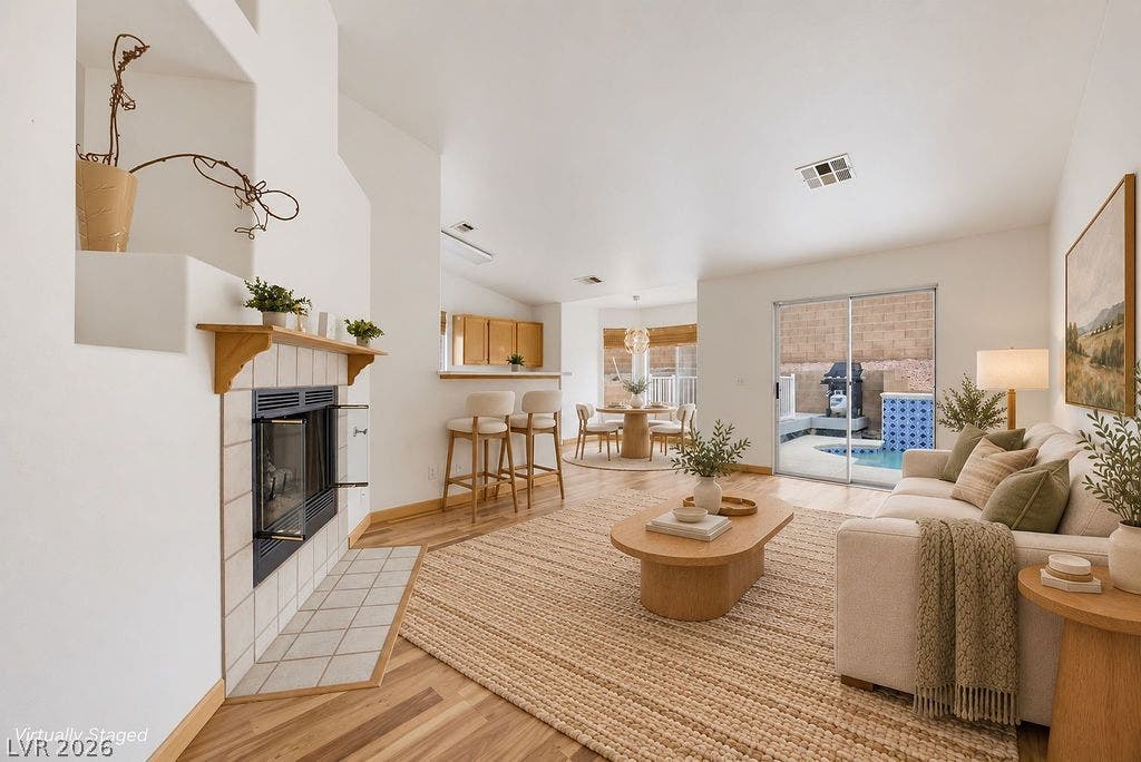409 Groft Way, Henderson, NV 89015 VIRTUALLY STAGED - An open floor plan connects the family room and fireplace to the backyard pool view.