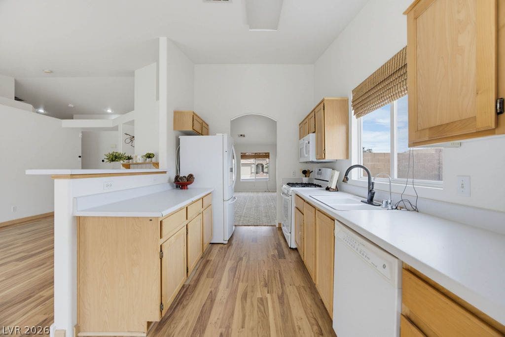 409 Groft Way, Henderson, NV 89015 Gleaming wood flooring complements the light cabinetry in this open kitchen layout.