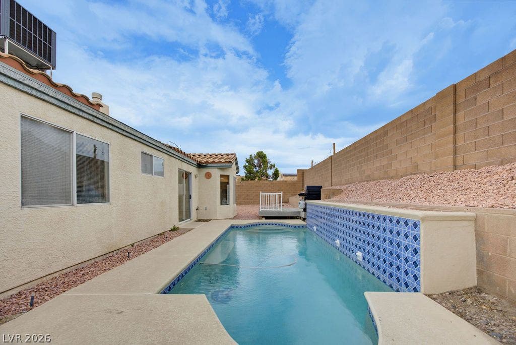 409 Groft Way, Henderson, NV 89015 A sparkling swimming pool highlights this low-maintenance private backyard enclosed by tall privacy walls.