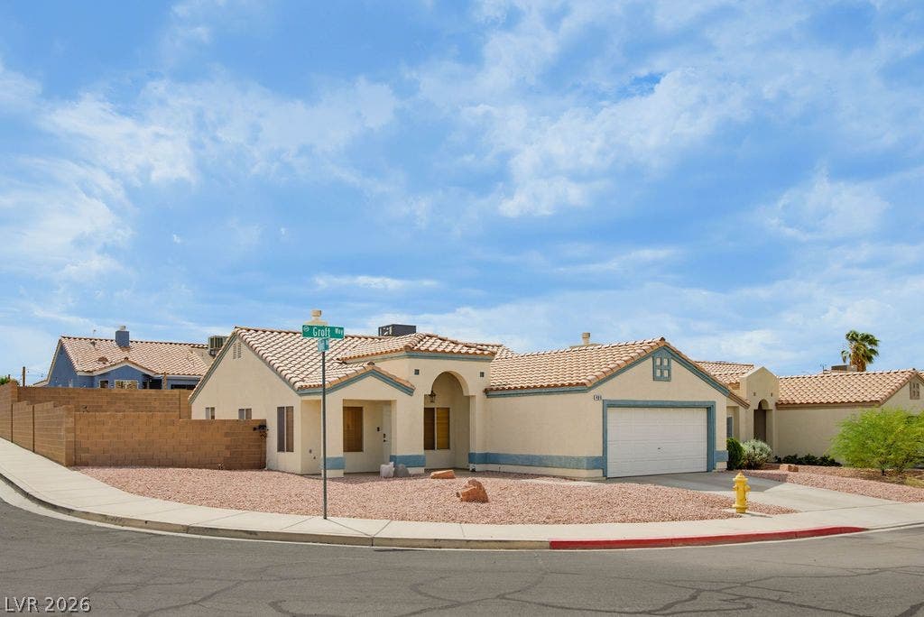 409 Groft Way, Henderson, NV 89015 An inviting stucco exterior features a tile roof and clean architectural lines on a corner lot.