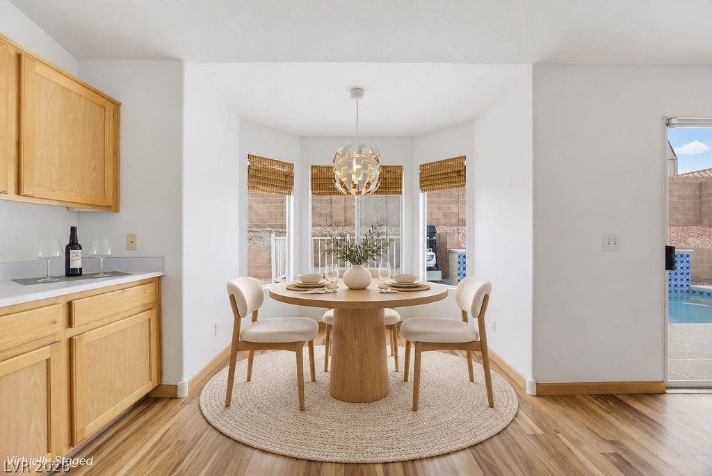 409 Groft Way, Henderson, NV 89015 VIRTUALLY STAGED - Gleaming laminate floors and a bright bay window enhance this charming dining area.
