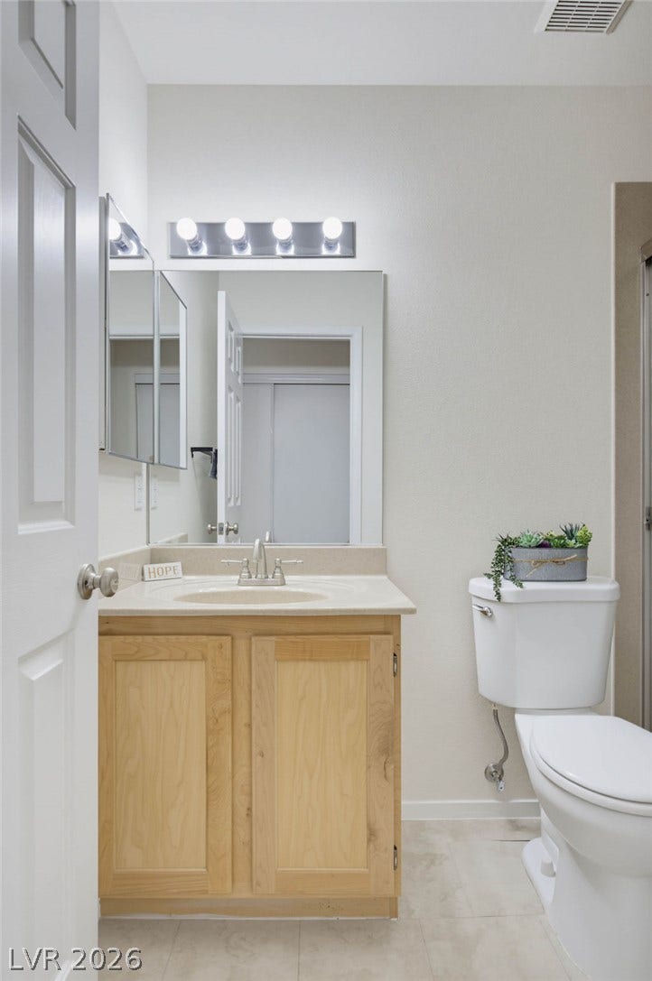 409 Groft Way, Henderson, NV 89015 Bathroom #2: A light wood vanity coordinates beautifully with the tiled flooring in this bathroom.
