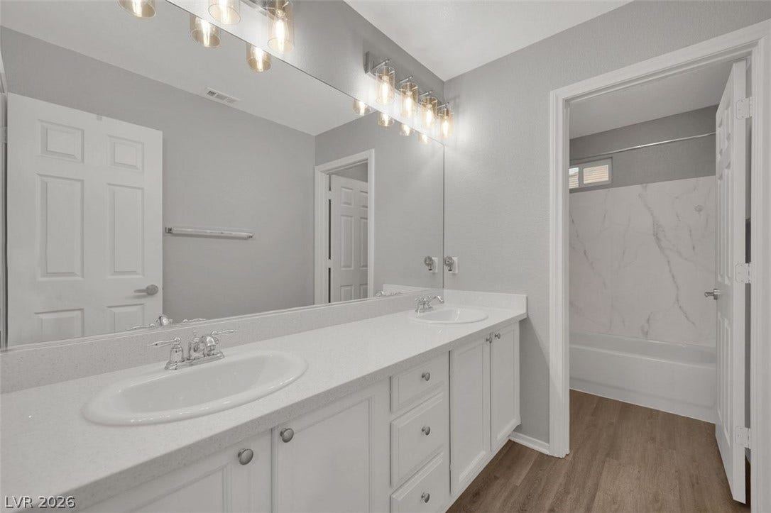 Clean lines and dual sinks define this well-appointed modern bathroom.