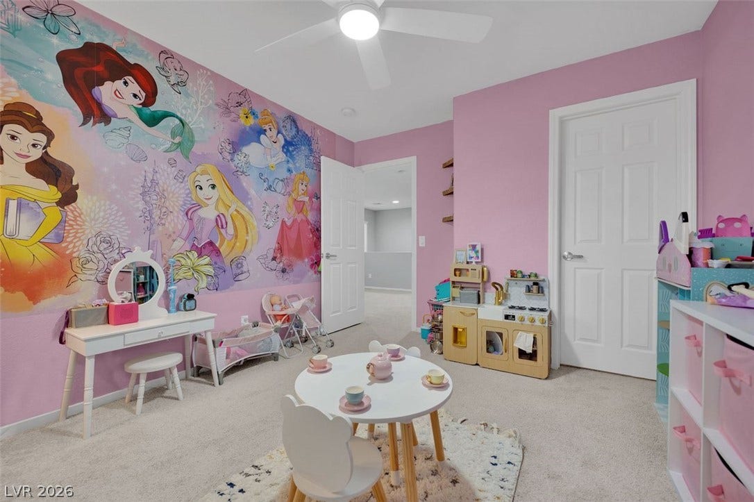 A spacious secondary bedroom features soft wall-to-wall carpeting and smooth white molding.
