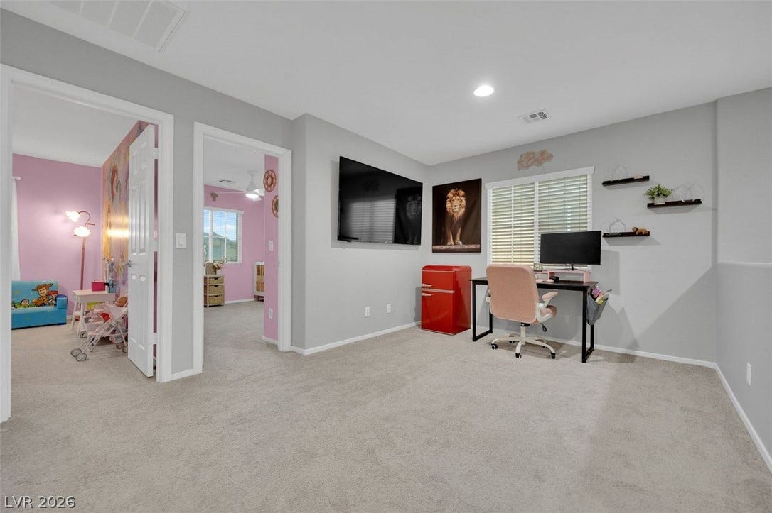 Recessed lighting and soft carpeting create a comfortable atmosphere in this versatile loft space.