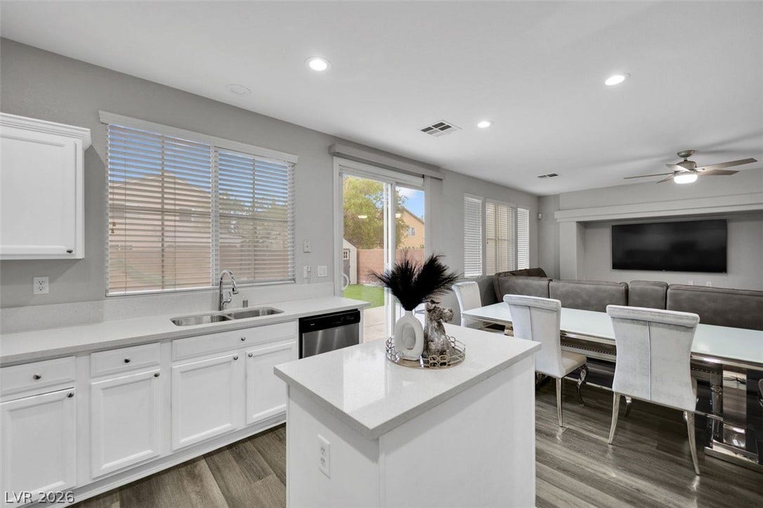 Gleaming quartz countertops pair with seamless open-concept design across this fluid kitchen layout.