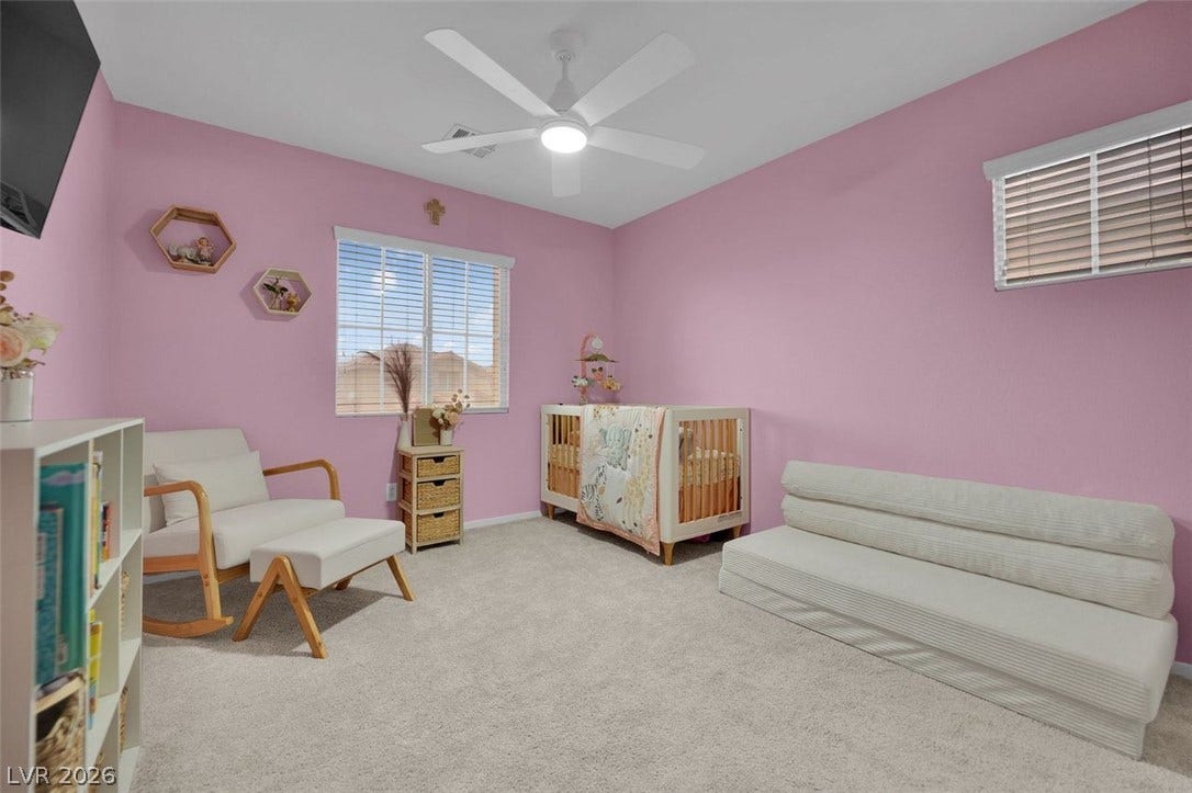 Plush carpeting and dual windows illuminate this versatile secondary living space.