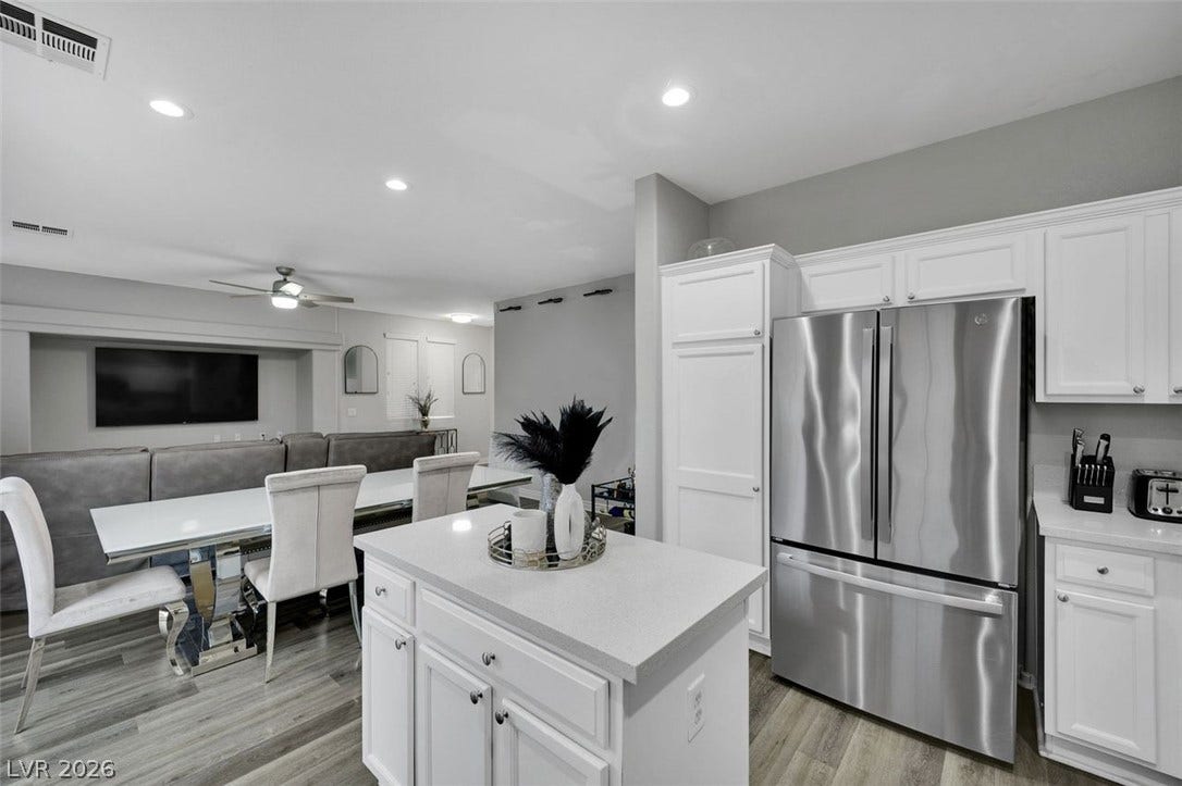 An open floor plan connects the modern kitchen seamlessly to the dining space.