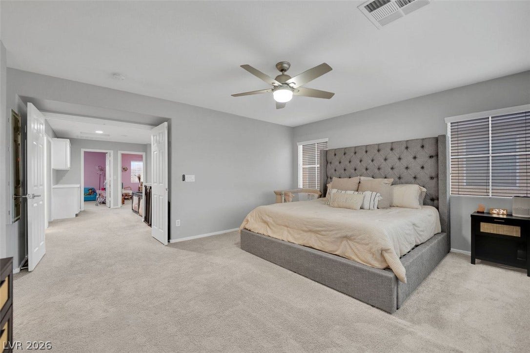 Plush wall-to-wall carpeting and clean architectural lines define this comfortable, airy bedroom retreat.
