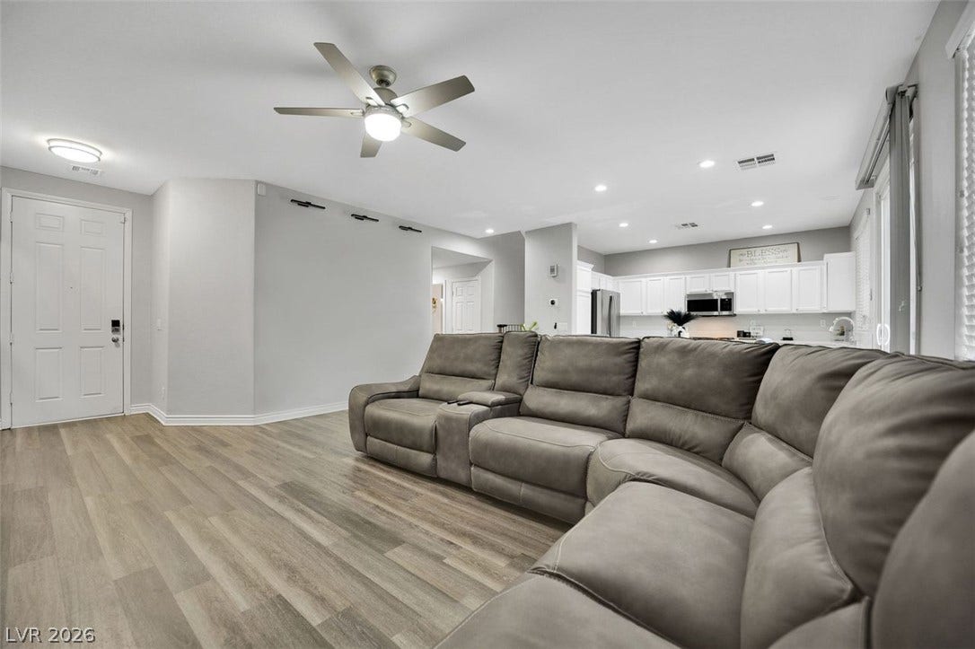 An open floor plan seamlessly connects the central living area with the adjacent kitchen.