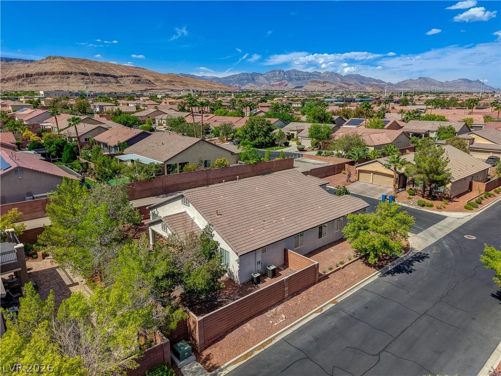 Nestled in a quiet neighborhood, this home features tile roofing and views of distant mountains.