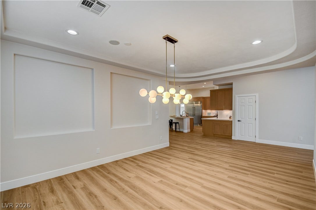 An open floorplan seamlessly connects the dining space to the kitchen beyond.