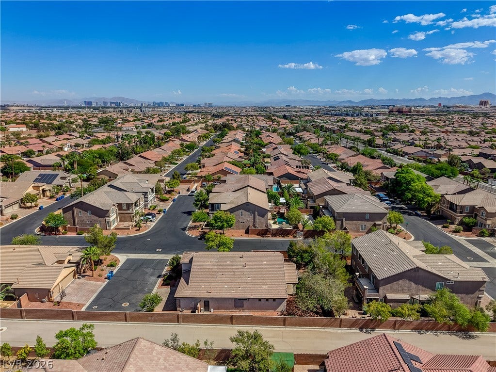An aerial perspective captures the sweeping neighborhood views stretching toward the distant mountain skyline.