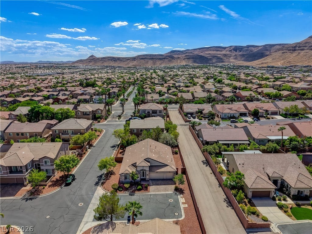 Dramatic mountain vistas frame this sprawling suburban neighborhood of tile-roofed homes.