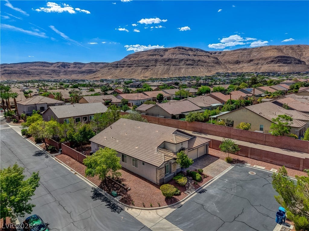 Dramatic mountain vistas rise above this desert community of tile-roofed homes.