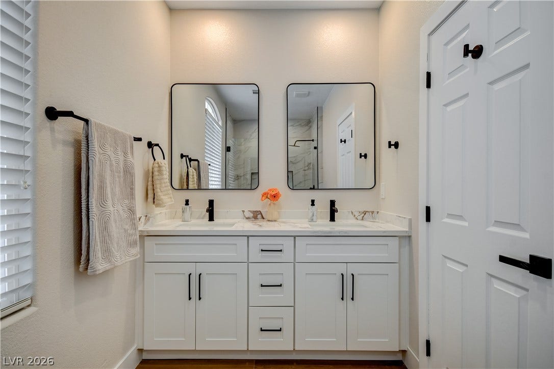 Clean lines and a spacious double vanity anchor this modern bathroom design.