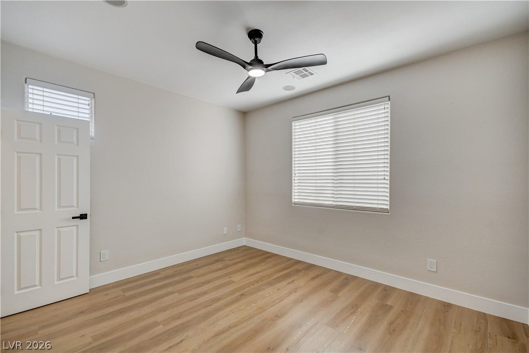 Smooth wood-style flooring and large windows create a pleasant, neutral setting.