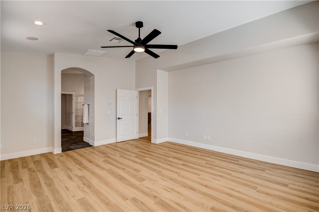 Warm wood flooring and clean architectural lines define this versatile space.