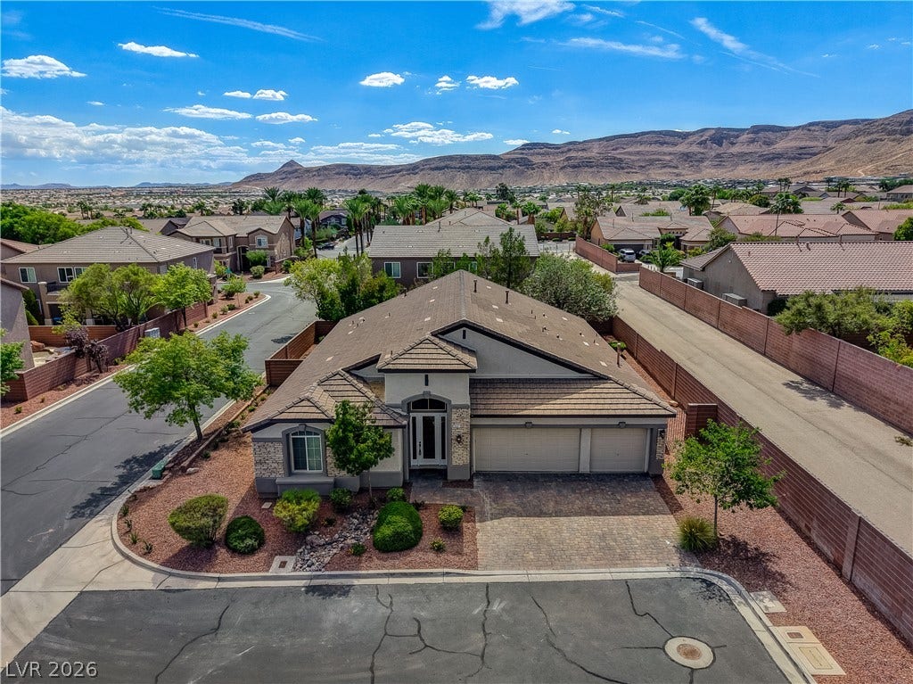 Dramatic mountain backdrops frame this elegant desert home nestled on a quiet street corner.