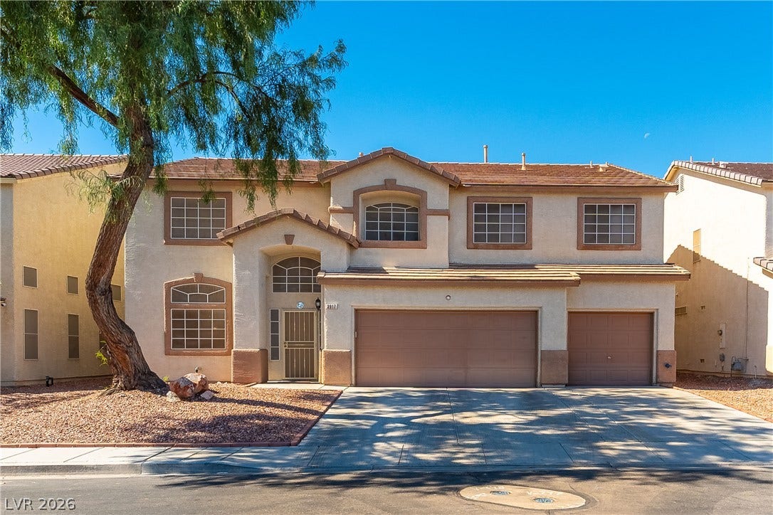 Stucco cladding and a tiled roof define the exterior of this two-story residence.