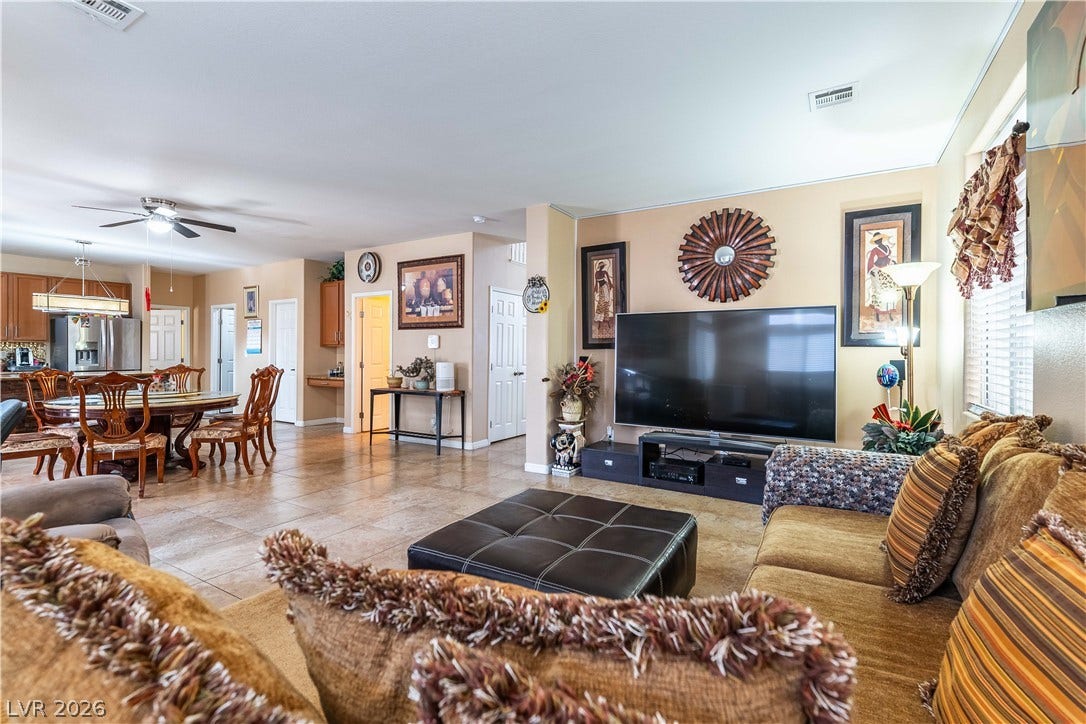 An open layout connects the living and dining areas over durable tile flooring.