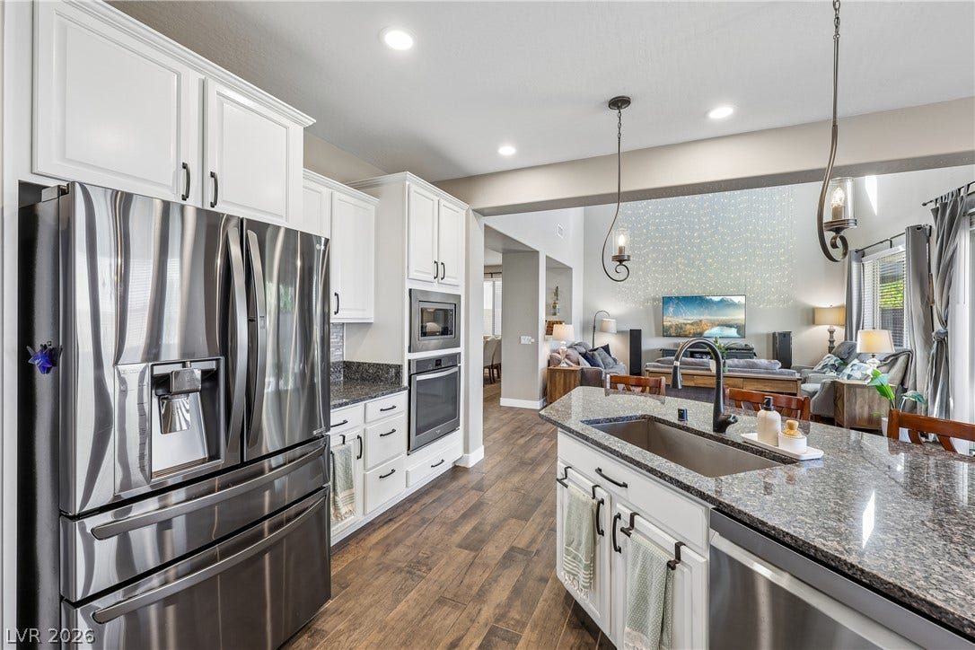 9490 Wild Valley Avenue, Las Vegas, NV 89148 Gleaming stone countertops and stainless steel appliances anchor a bright, modern culinary space.
