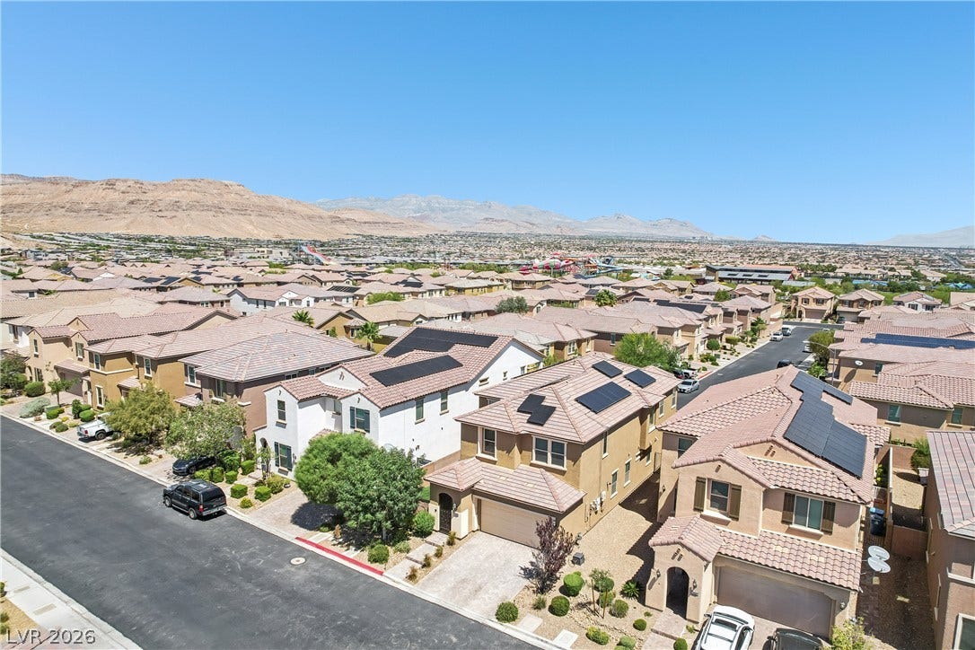 9490 Wild Valley Avenue, Las Vegas, NV 89148 A neighborhood aerial perspective showcases tile rooflines under a clear sky.