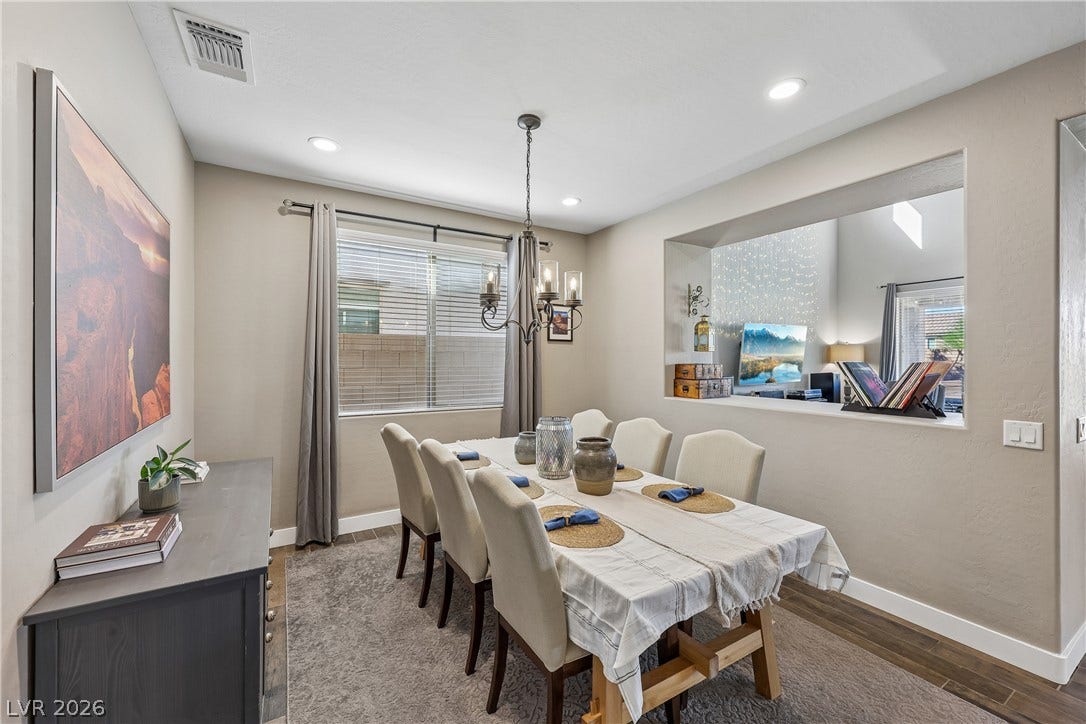 9490 Wild Valley Avenue, Las Vegas, NV 89148 An open pass-through window connects this dining space with the adjacent living area.