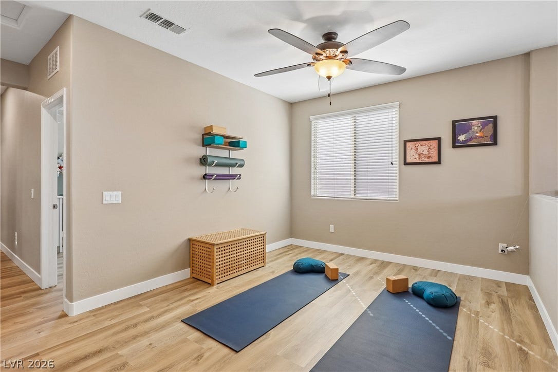 9490 Wild Valley Avenue, Las Vegas, NV 89148 Smooth wood floors and a wide window define this versatile interior space.