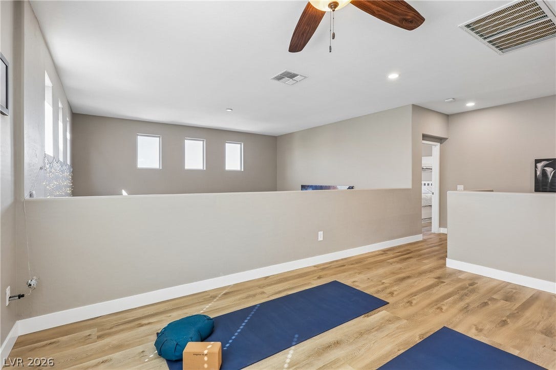 9490 Wild Valley Avenue, Las Vegas, NV 89148 Gleaming wood floors anchor this open upstairs loft space featuring high ceilings.
