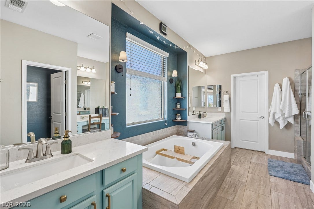 9490 Wild Valley Avenue, Las Vegas, NV 89148 Stone counters and a deep soaking tub anchor this spacious primary bath.