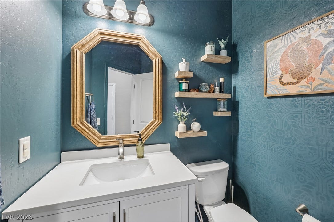 9490 Wild Valley Avenue, Las Vegas, NV 89148 A stylish vanity with solid counters and integrated storage maximizes space in this half bath.