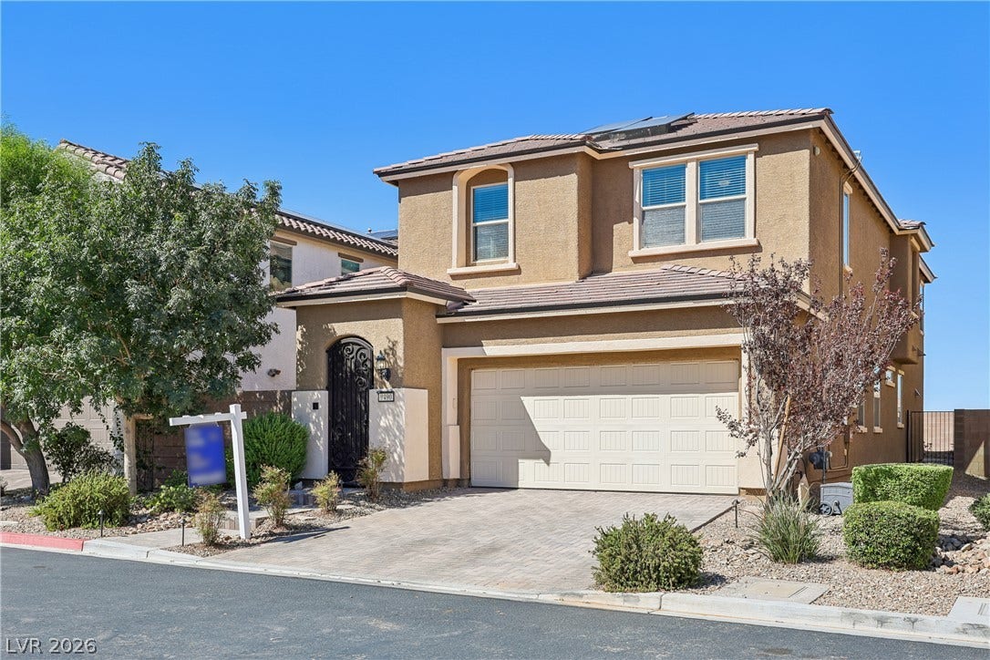 9490 Wild Valley Avenue, Las Vegas, NV 89148 An inviting exterior features stucco finish and a modern paved driveway leading to the garage.