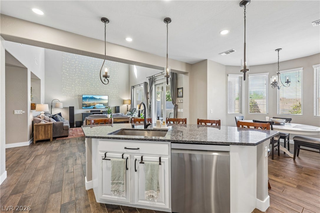 9490 Wild Valley Avenue, Las Vegas, NV 89148 An open kitchen looks out over the living areas and features rich wood-look flooring.