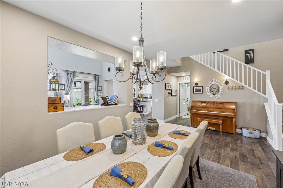 9490 Wild Valley Avenue, Las Vegas, NV 89148 An open dining area features smooth tile floors, neutral walls, and a classic central chandelier.