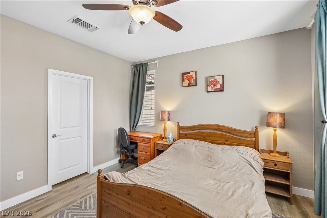 9490 Wild Valley Avenue, Las Vegas, NV 89148 Smooth wood-look flooring and tall baseboards anchor this peaceful private bedroom.