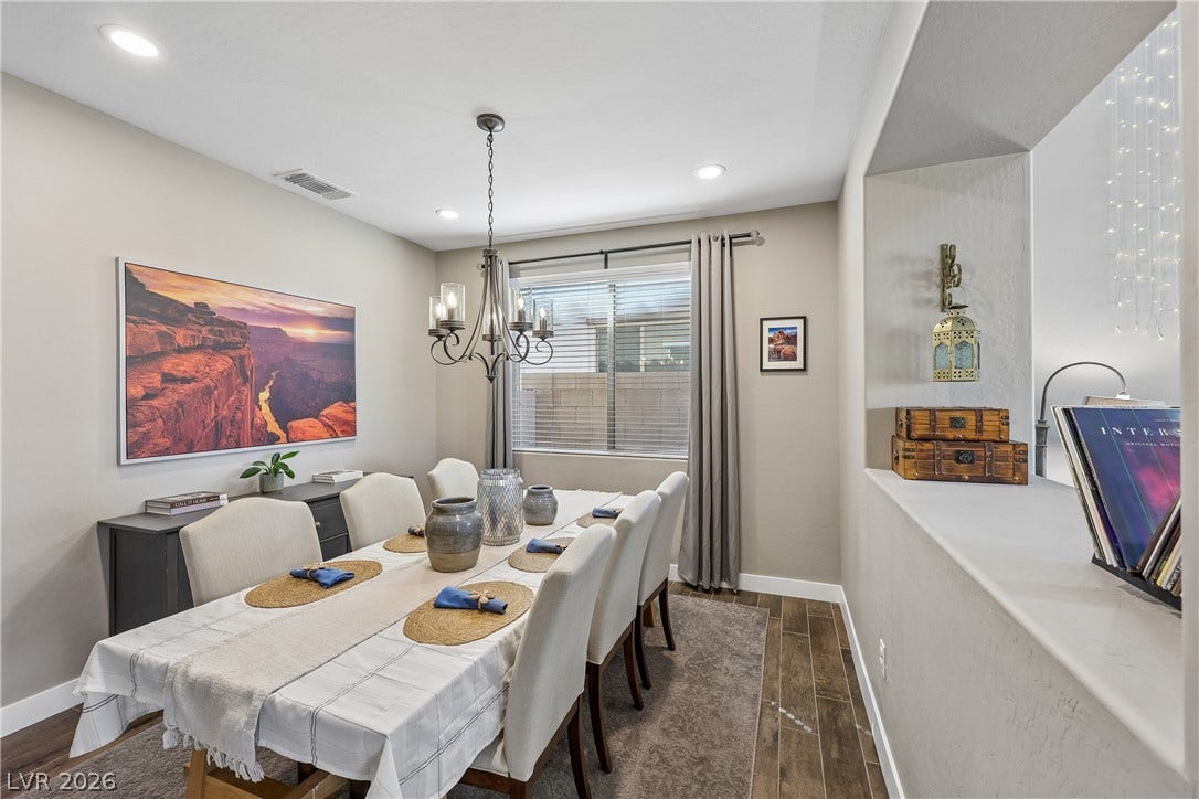 9490 Wild Valley Avenue, Las Vegas, NV 89148 Recessed lighting illuminates this dining room featuring wood-look tile flooring and a pass-through wall.