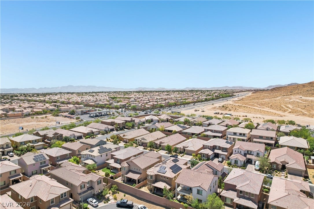 9490 Wild Valley Avenue, Las Vegas, NV 89148 Panoramic neighborhood vistas stretch toward distant mountains under a clear blue sky.
